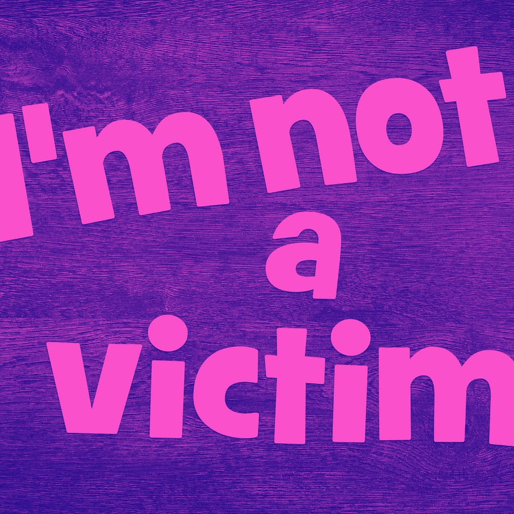 Image of the words I am not a victim in pink.