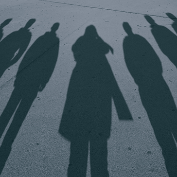 A Group Of Shadows On The Pavement