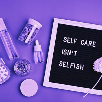 The Dangers of People Pleasing in Recovery: How I Overcame It 4 The words Self-care isn't selfish on a board with self-care items