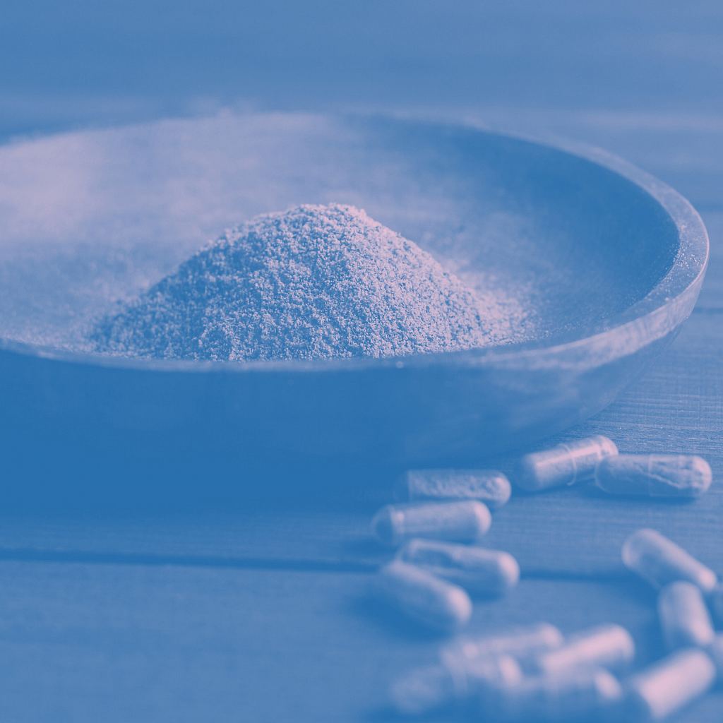 Comprehensive Guide To Navigating Kratom Withdrawal 6 A Pile Of Kratom Powder On A Plate With A Pile Of Kratom Filled Capsules Next To It.