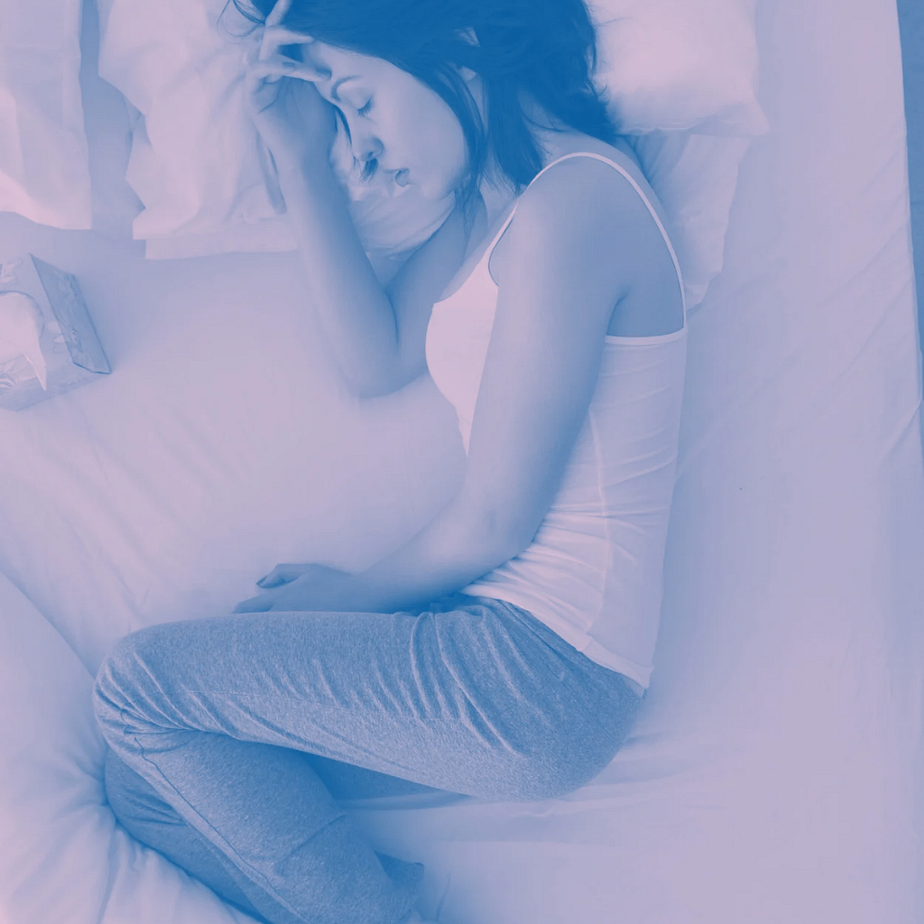 Comprehensive Guide To Navigating Kratom Withdrawal 5 A Woman Curled Up In Bed Suffering From Kratom Withdrawal.