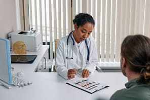 Understanding Tramadol Withdrawal Symptoms: A Comprehensive Guide 3 A Doctor Sitting With Patient In An Office In Front Of Window.