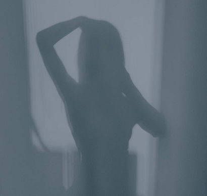 Image Of Woman Taking A Photo As Her Shadow With A Window Behind Her.