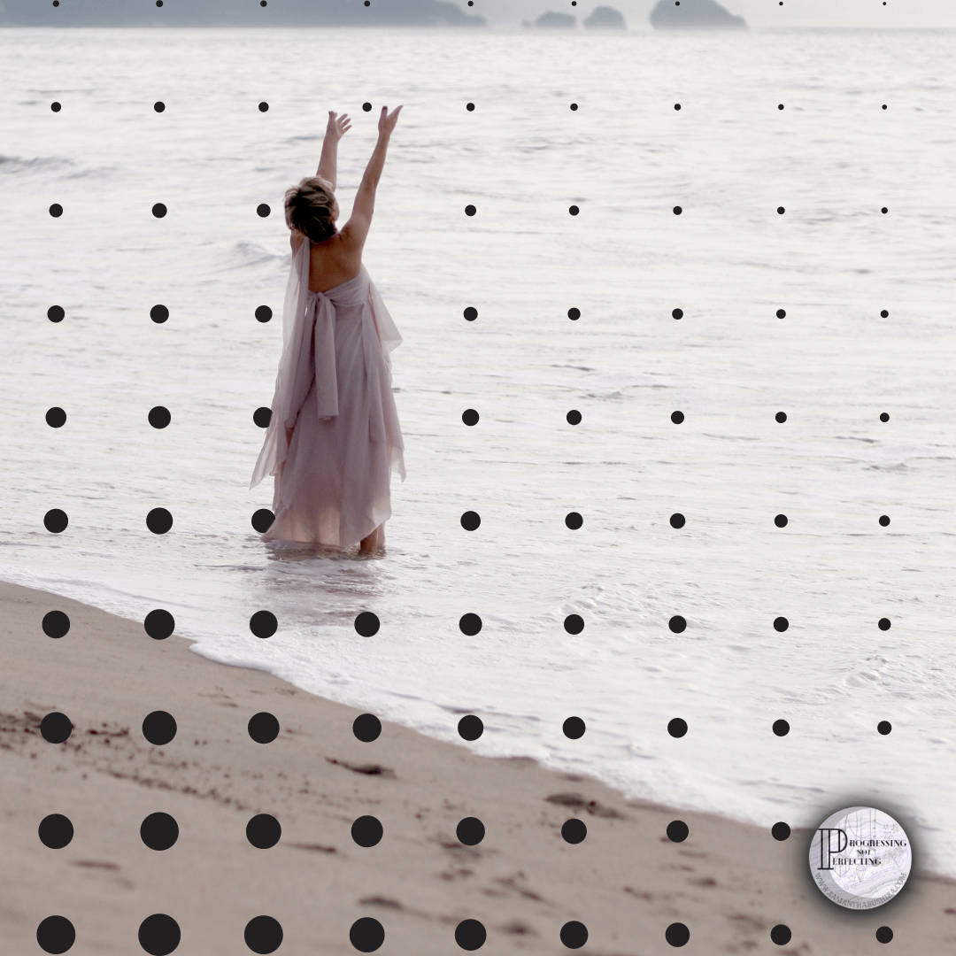 3 A Woman In A Dress Standing In The Water