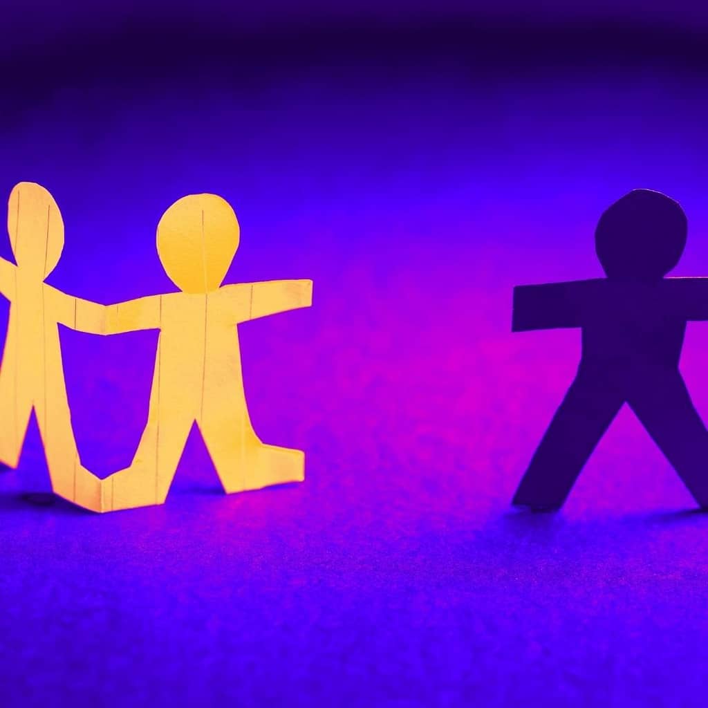 Paper people with one of the people disconnected and cut off.