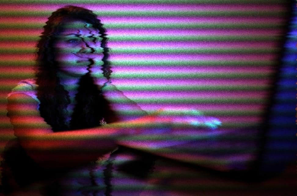 Social Media Addiction: What It Is and What to Do About It 4 Photo of teen sitting at a computer covering her eyes but peeking through her fingers at her computer screen.
